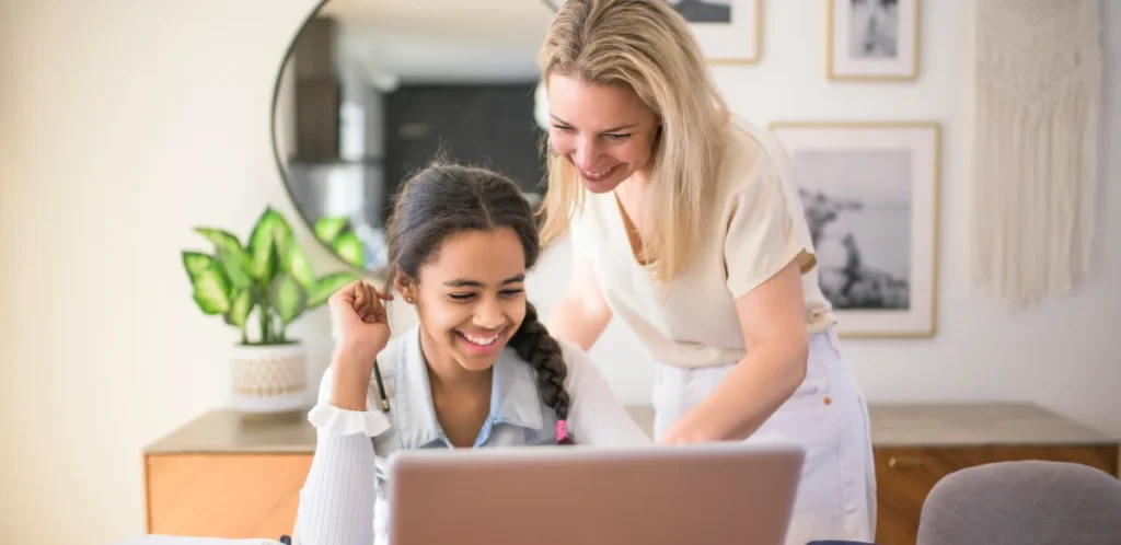mom and girl looking the computer
